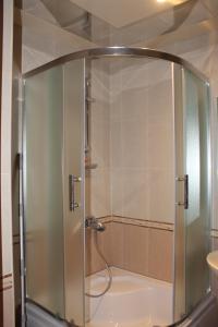 a shower with a glass door in a bathroom at Apartment at Jafar Khandan 200 in Baku