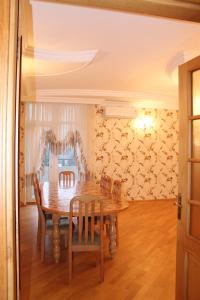 a dining room with a wooden table and chairs at Apartment at Jafar Khandan 200 in Baku