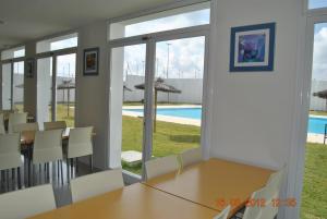 a dining room with a table and chairs and a pool at Albergue Inturjoven Jerez De La Frontera in Jerez de la Frontera