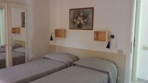 a room with two beds and a mirror at Villa Carolina in Fara San Martino