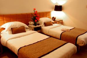 Кровать или кровати в номере Hotel Palace Heights