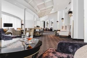 a hotel lobby with a glass of wine on a table at Krumers Alpin – Your Mountain Oasis in Seefeld in Tirol