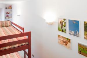 a bedroom with a bunk bed and pictures on the wall at Casa Nia in Madonna di Campiglio