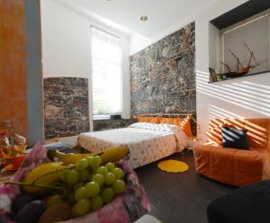 a room with a bed, a table, and a window at B&B dell'Acquario in Genoa