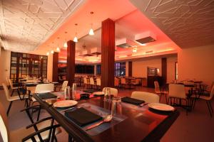 a large dining room with a table and chairs at The Club in Bangalore