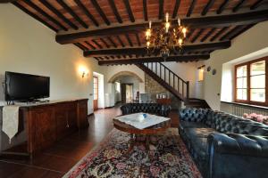 a living room with a couch and a tv at Casa Chiara by VacaVilla in Preggio