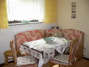 einen Tisch und Stühle in einem Wohnzimmer mit einem Tisch und einem Sofa in der Unterkunft Serene Apartment with Private Terrace in Wismar in Wismar