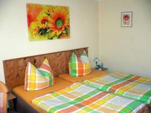 ein Schlafzimmer mit einem Bett mit einem Blumengemälde an der Wand in der Unterkunft Serene Apartment with Private Terrace in Wismar in Wismar