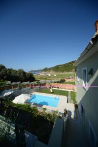 a view of a swimming pool from a house at Aselinos Suites in Koukounaries