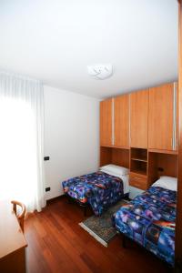 a hotel room with two beds and a window at Round Venice in Marghera