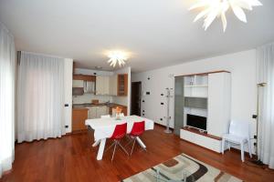a living room with a white table and red chairs at Round Venice in Marghera
