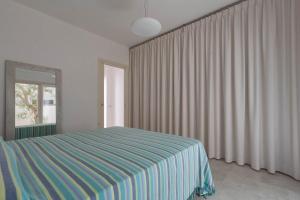 レウカにあるVilletta Federica by BarbarHouseのベッドルーム1室(ベッド1台付)、窓(カーテン付)