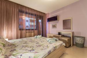 a bedroom with a large bed and a window at Luxury One Bedroom Suite, Doorman, Limited Access, Lozenec Area in Sofia