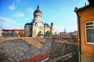 an old building with a tower on top of a roof at Andrea Apartments in Cluj-Napoca
