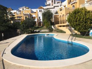 a swimming pool in front of some buildings at ATALAYA 24 in La Manga del Mar Menor