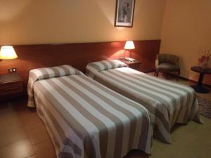 Ein Bett oder Betten in einem Zimmer der Unterkunft Hotel Due Fontane