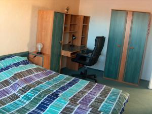 シュマルカルデンにあるFerienwohnung Trollmannのベッドルーム1室(ベッド1台、デスク、椅子付)