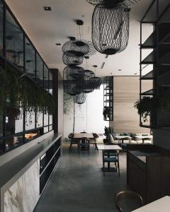 a living room with tables and chairs and chandeliers at DingDong Bukit Bintang Luxury Suites,3mi to PaVlion mall in Kuala Lumpur