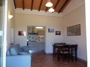 a living room with a table and a kitchen at La Casa Di Ninetta in Rio Marina