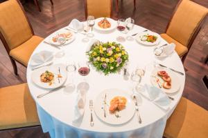 a white table with plates of food on it at Crystal Palace Boutique Hotel in Sofia