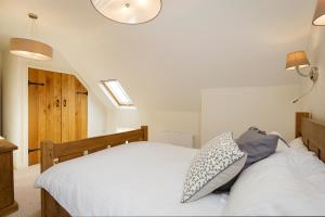 
a bedroom with a bed and a dresser at 1 Collared Dove Barn in Stoke on Trent
