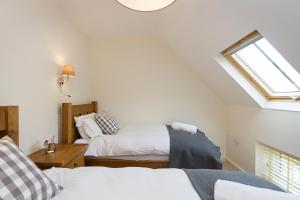 
a bedroom with a bed and a window at 1 Collared Dove Barn in Stoke on Trent
