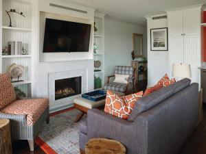 a living room with a couch and a fireplace at Inn By the Sea in Cape Elizabeth