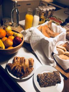 una mesa con platos de bollería, fruta y leche en Hotel Old Sarajevo, en Sarajevo