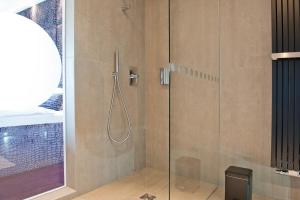 a shower with a glass door in a bathroom at G Design Hotel in Ljubljana