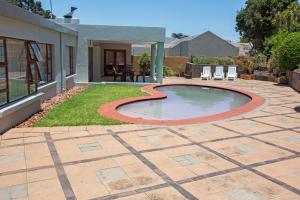 a patio with a small pool in the middle of a yard at Spacious Garden Cottage in Johannesburg