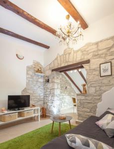 a living room with a stone wall at Apartments Mario in Pula