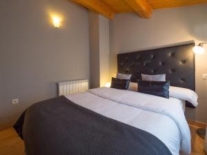 a bedroom with a large bed with a large headboard at El Despertar in Boltaña