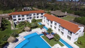 an aerial view of a mansion with a swimming pool at Punta del Este Arenas Hotel in Punta del Este