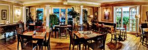 a restaurant with tables and chairs in a room at Chelsea Pub and Inn in Atlantic City
