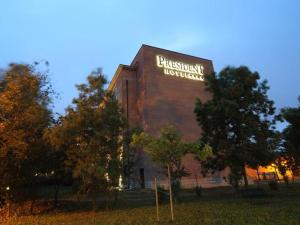 a large building with a sign on the side of it at Hotel President in Correggio