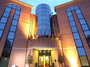 a large building with two towers on top of it at Hotel President in Correggio