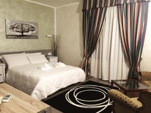 Ένα ή περισσότερα κρεβάτια σε δωμάτιο στο Ai Colli