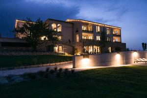 a large building with lights in front of it at Can Alemany in Santa Margarita de Mombúy
