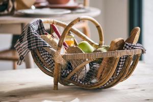 a basket filled with bread and condiments on a table at Can Alemany in Santa Margarita de Mombúy
