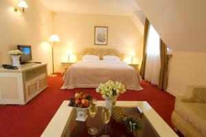 a hotel room with a bed and a table with fruit on it at Casa Boyana Boutique Hotel in Sofia