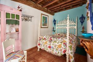 a bedroom with a bed with a white canopy at Sotam Country House in Góis +29 photos