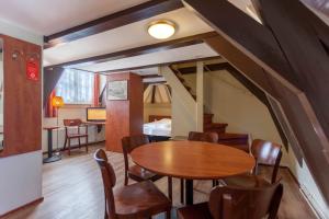 a dining room with a wooden table and chairs at A-Train Hotel in Amsterdam