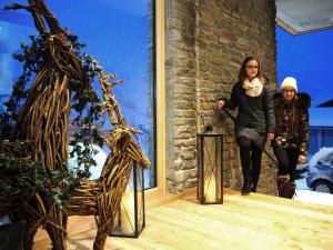 two women walking in a room next to a window at DAV-Haus (Alpenverein) in Obertauern