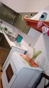 a kitchen with a sink and a counter with vegetables on it at DiVino in Villa Viani +48 photos