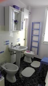a bathroom with a sink and a toilet and a sink at DiVino in Villa Viani