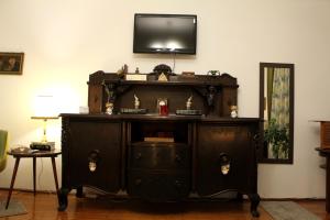 an old wooden cabinet with a tv on top of it at La Bella in Sibiu