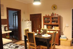 a kitchen with a table and a white refrigerator at La Bella in Sibiu