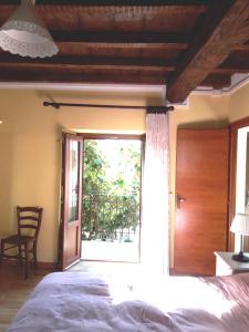 a bedroom with a bed and a sliding glass door at Talonno il frutteto in Invorio Inferiore