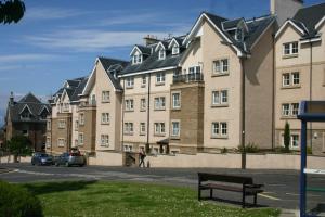 a large apartment building with a bench in front of it at No 10 Royal Apartments in North Berwick