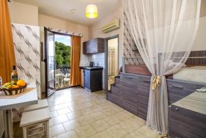 a room with a kitchen with a sink and a counter at Takis Hotel Apartments in Ialysos